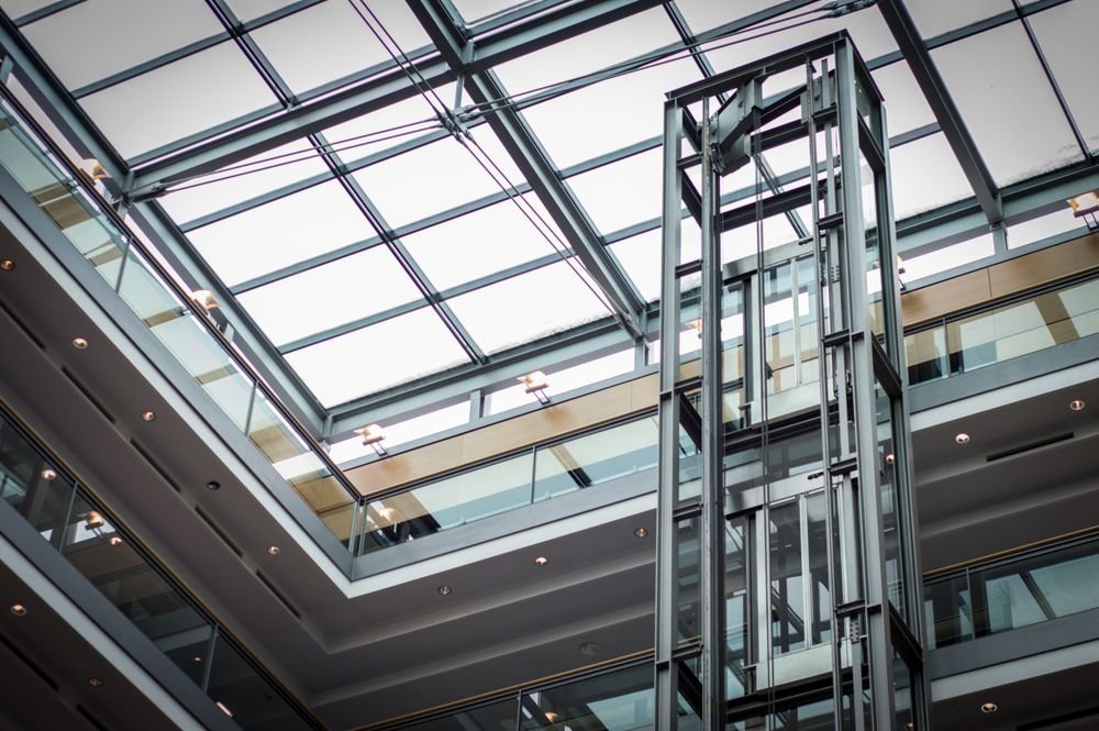 Glass elevator serving a modern multi-storey building