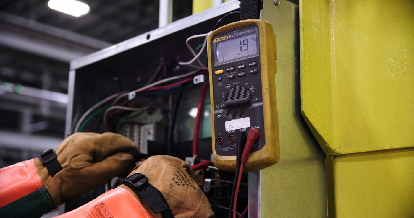 Technician checking an electrical control panel